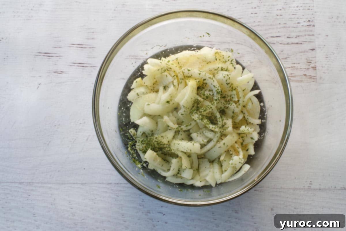 Microwaved onion mixture in glass bowl, softened and aromatic