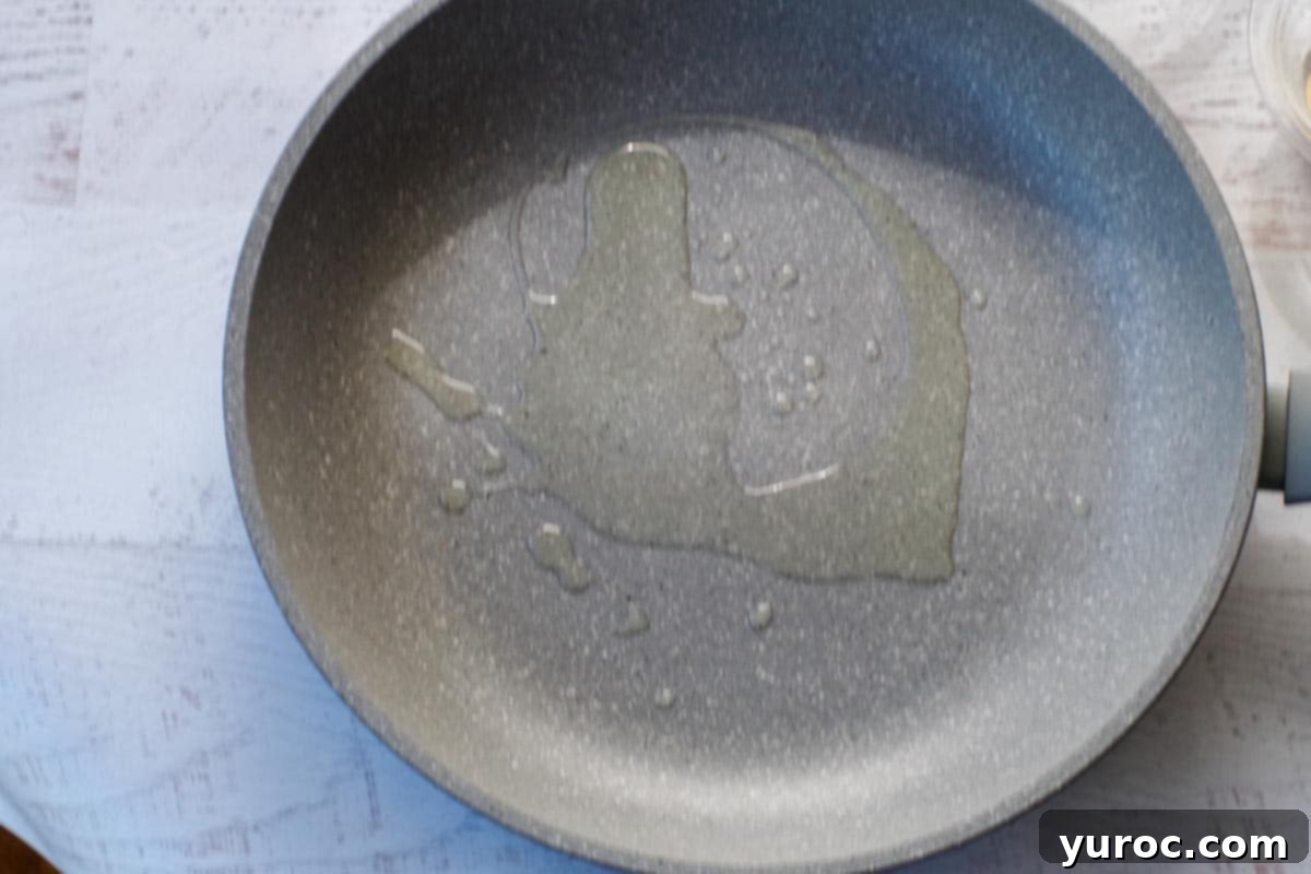 oil added to skillet, shimmering slightly as it heats