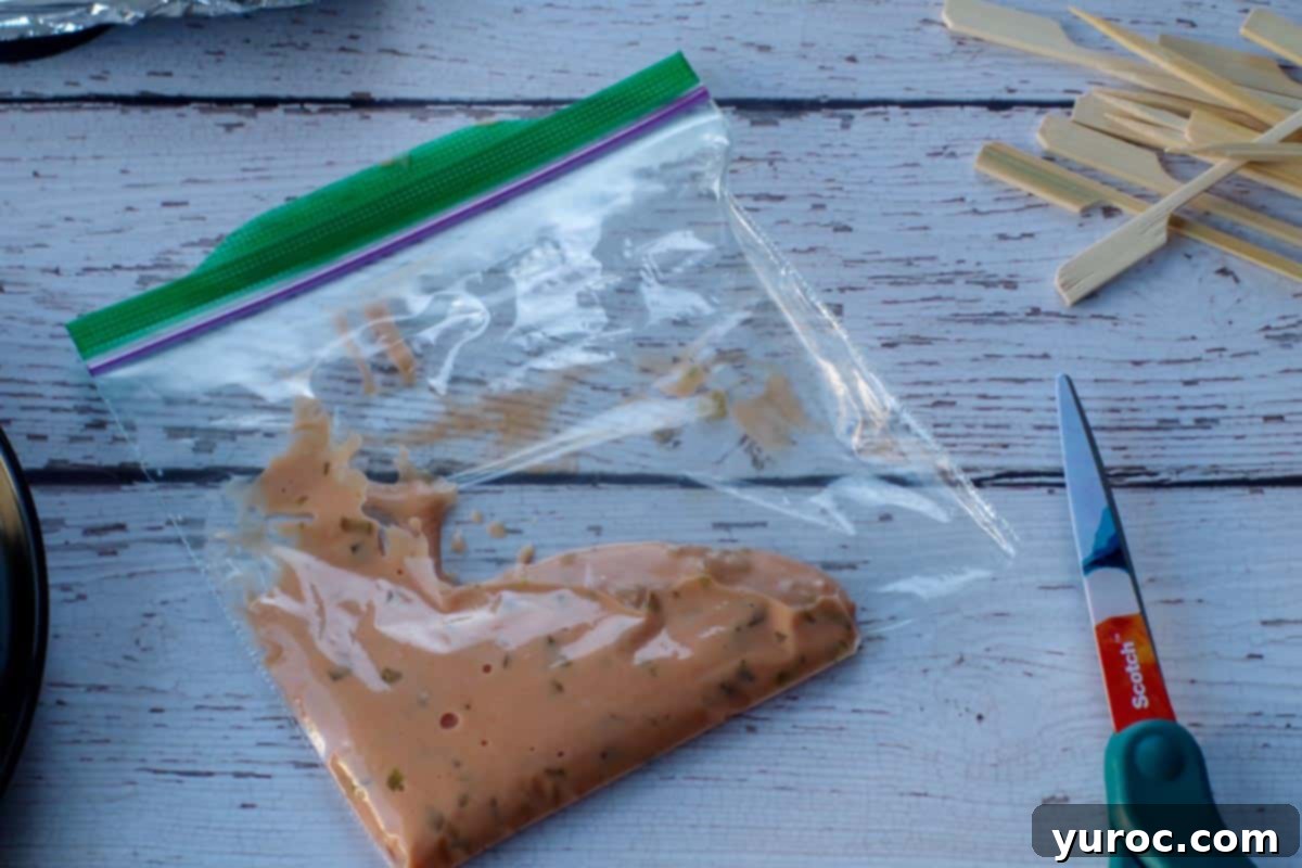 A Ziploc bag filled with the creamy Big Mac special sauce, with a small corner snipped off, prepared for drizzling.