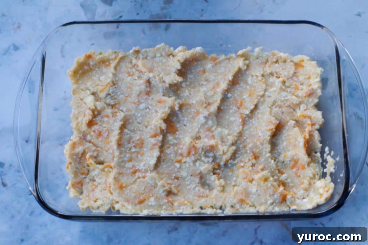 Easy Weeknight Pierogi Casserole 10 mashed potato mixed spread over the noodles in glass pan