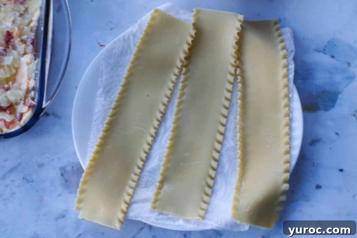 Easy Weeknight Pierogi Casserole 6 3 partially cooked lasagna noodles on a paper towel covered plate