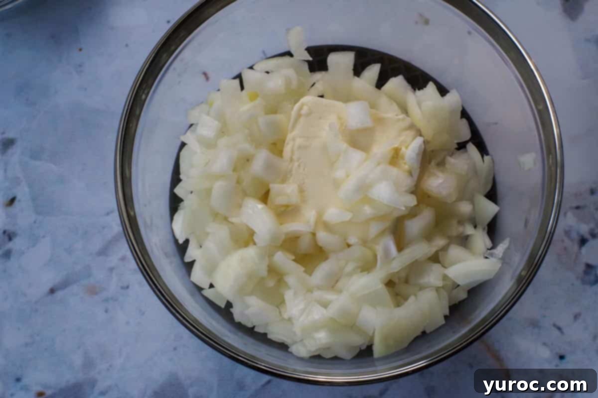 Easy Weeknight Pierogi Casserole 7 onions and butter in a glass microwave safe bowl