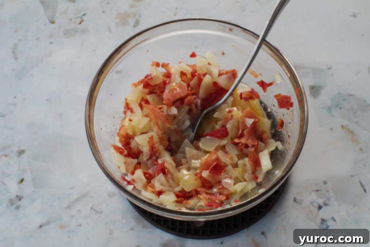 Easy Weeknight Pierogi Casserole 8 bacon, butter and onion mixed together in glass bowl