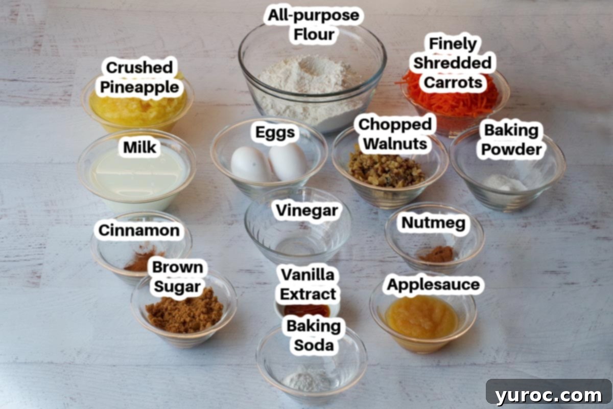 A vibrant display of all the essential ingredients for sheet pan carrot cake pancakes, neatly arranged and labeled in individual glass bowls, ready for mixing. From finely shredded carrots to golden brown sugar, each element is showcased for clarity.