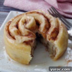 Healthy Cinnamon Swirl Mug Treat 22 healthy cinnamon roll in a mug cut open on a white plate, with a pink napkin in the background