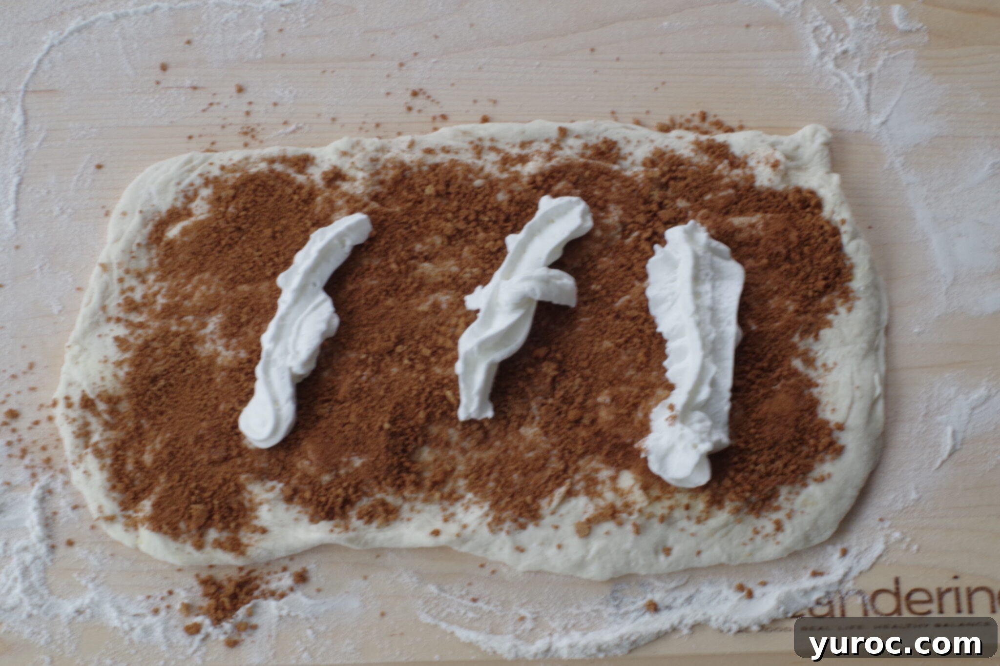 Healthy Cinnamon Swirl Mug Treat 8 whipped cream added to brown sugar cinnamon mixture on dough rectangle