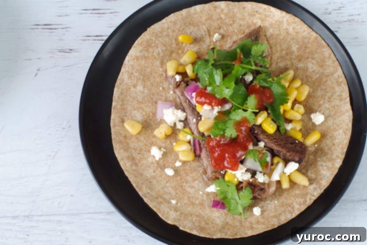 Beef and toppings added to tortillas