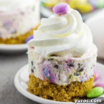 An inviting no-bake Mini Easter Cheesecake on a white plate, with another in the softly blurred background.