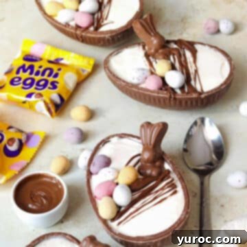 Three individual Easter egg cheesecakes, adorned with mini eggs and chocolate, alongside their packaging and a spoon.