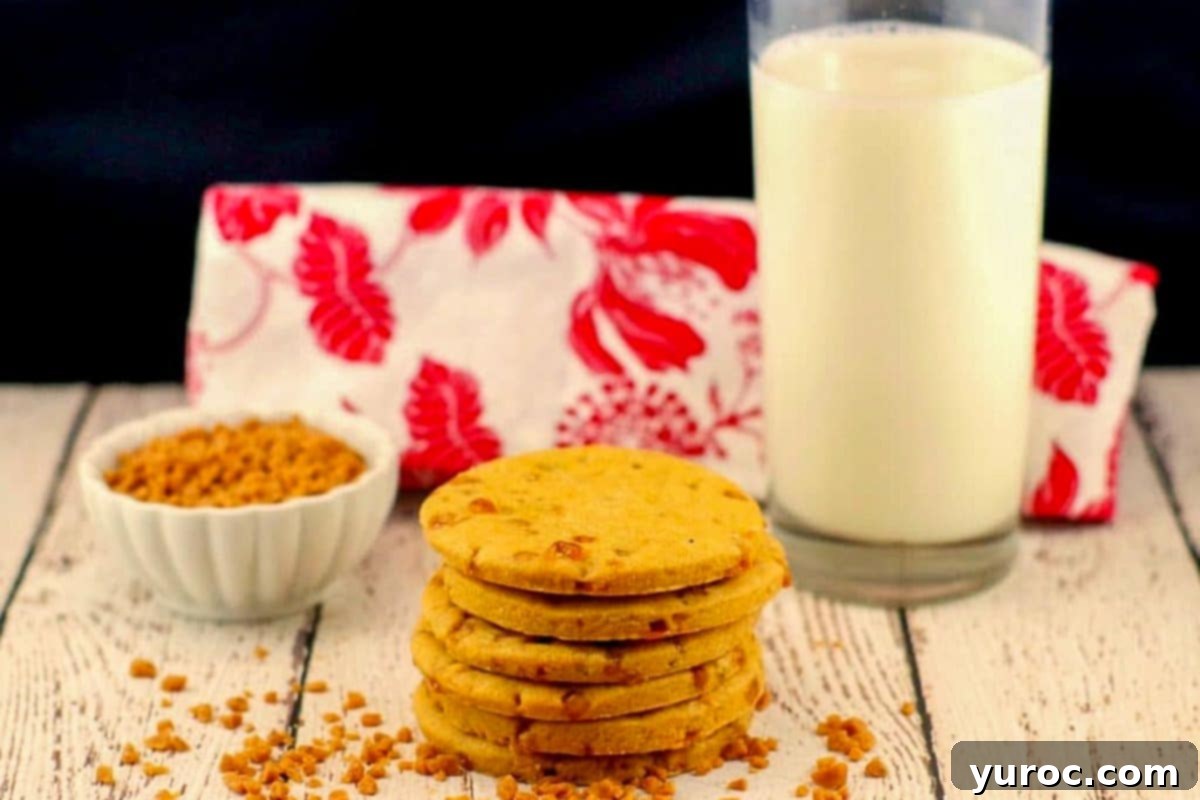Gourmet Butterscotch Toffee Cookies 2 stack of butterscotch toffee cookies with a glass of milk and red and white tea towel in the background