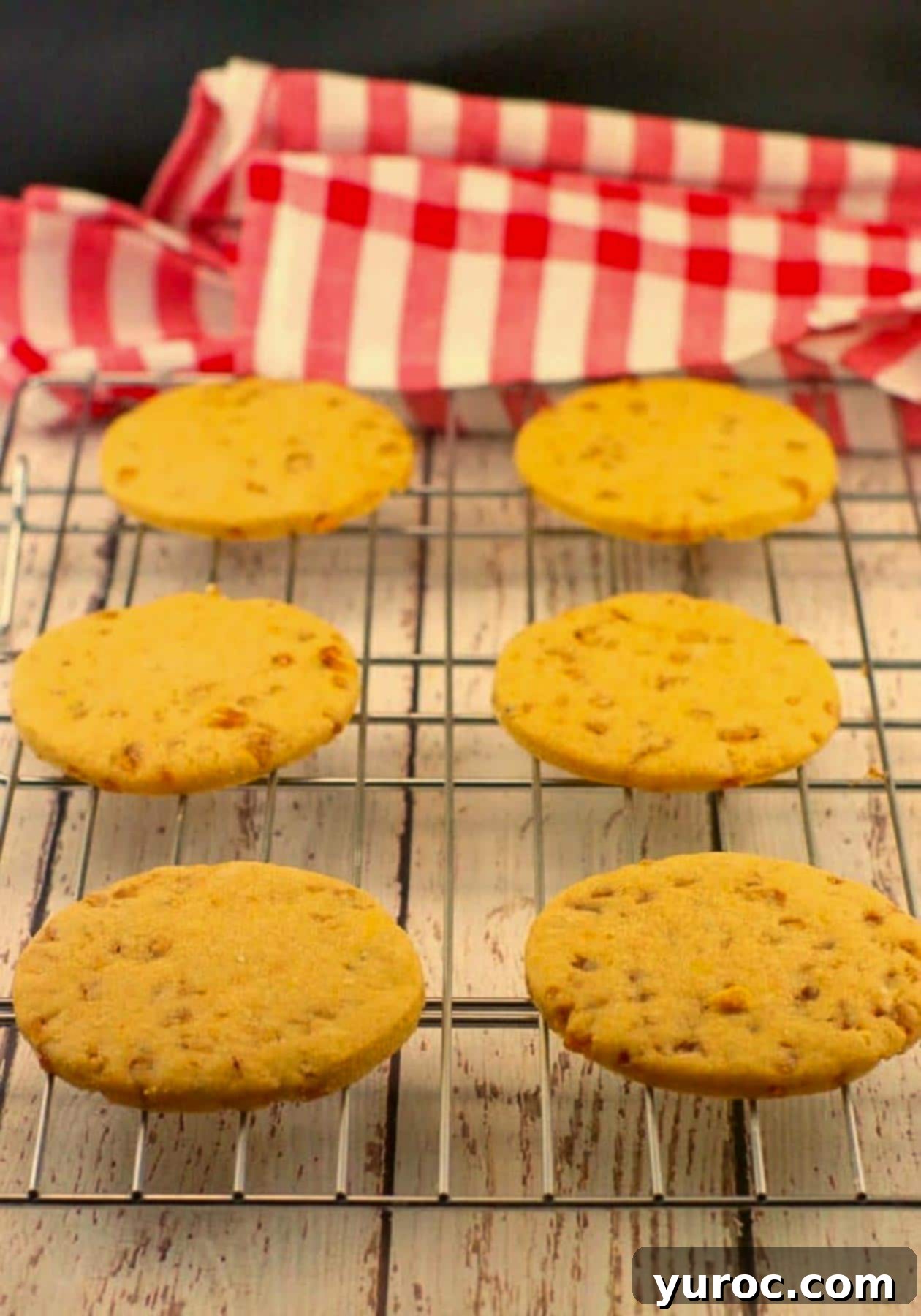 Gourmet Butterscotch Toffee Cookies 7 butterscotch toffee cookies on a wire cooling rack, with checkered red and white tablecloth