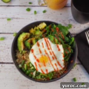 Avocado Breakfast Power Bowl 13 Avocado breakfast bowl in a black bowl with coffee and juice in the background and black linen napkin with fork, on right side