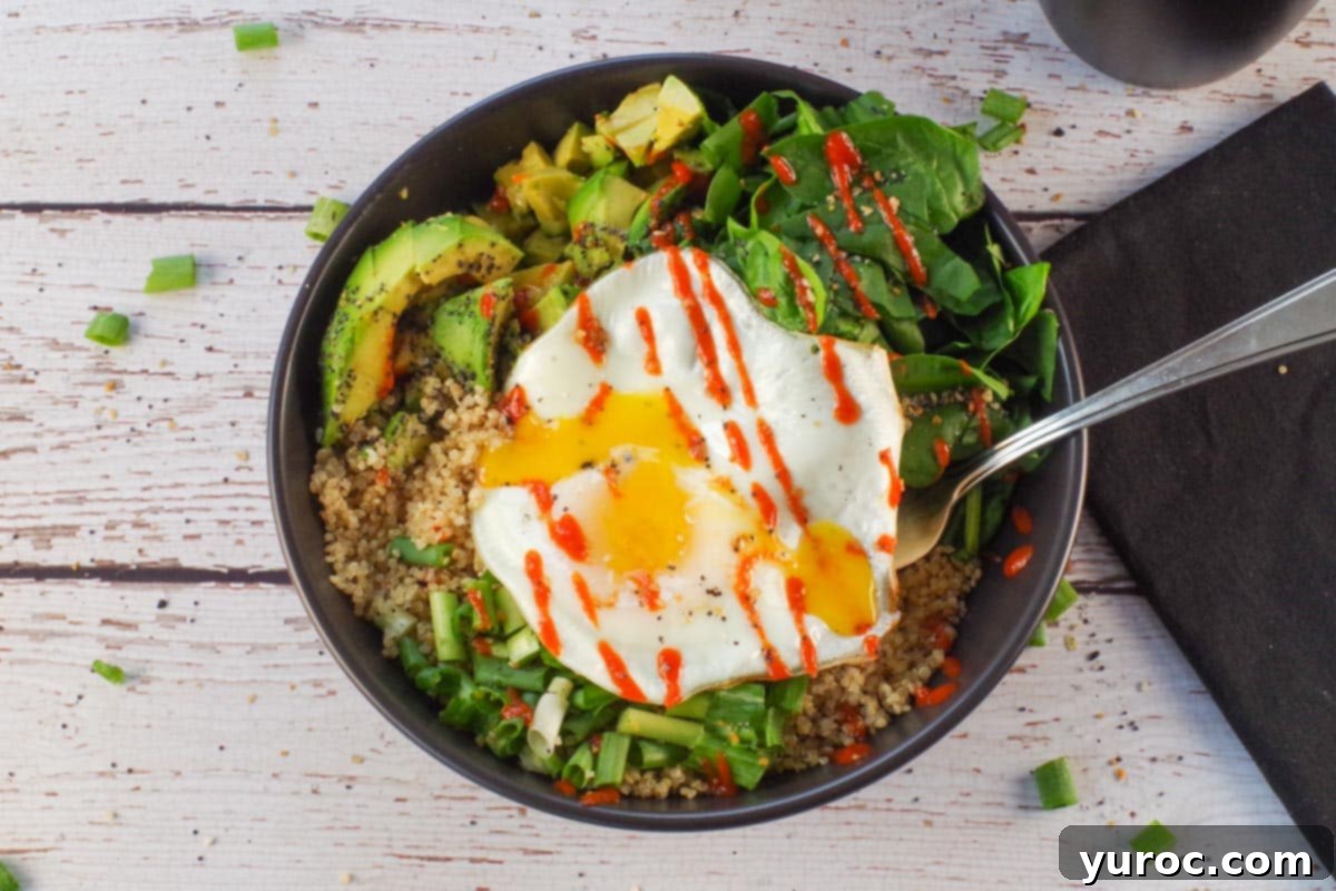 Avocado Breakfast Power Bowl 10 Avocado breakfast bowl in a black bowl with black linen napkin with fork, on right side