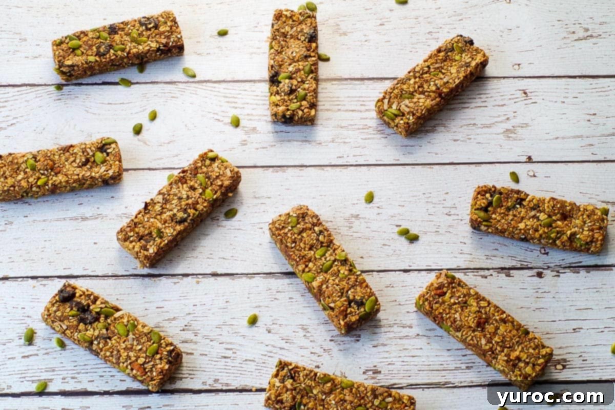 Ten Almond Butter Granola Bars neatly arranged on a faux white wood surface, showcasing their delicious appearance.