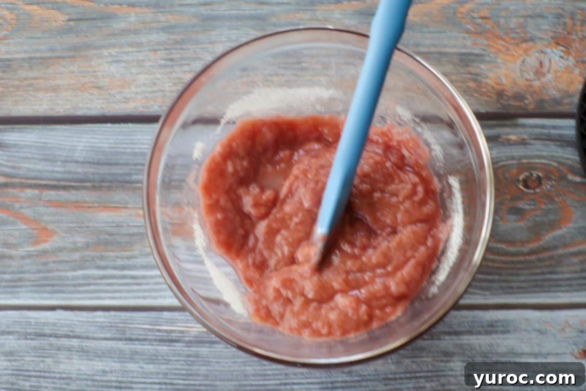 rhubarb puree mixed with sugar in glass bowl