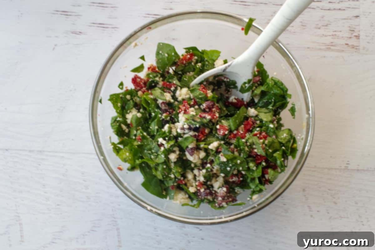 filling ingredients mixed well in a glass bowl with spoon