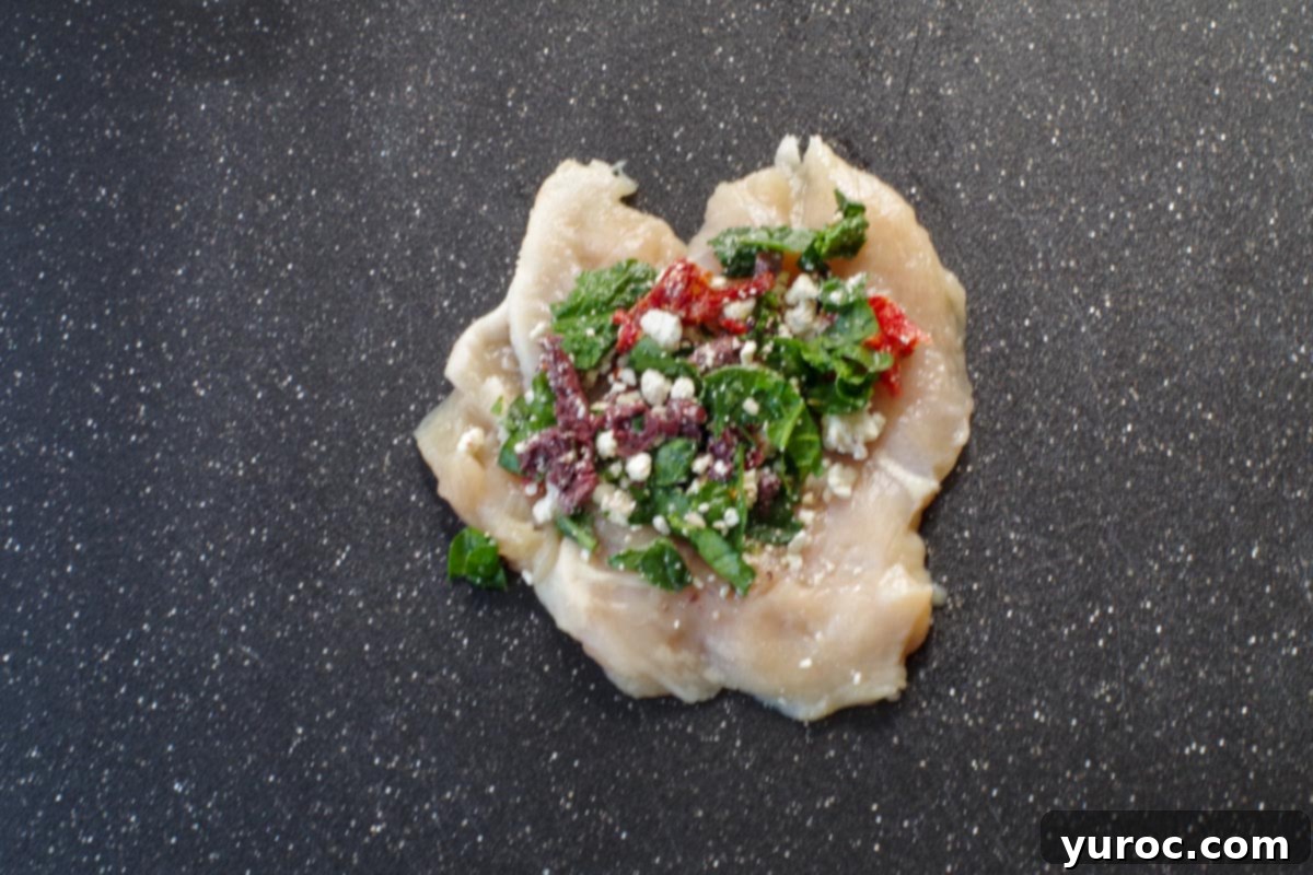 filling put on chicken breast on cutting board