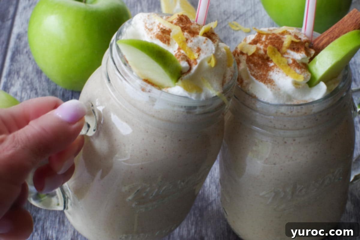 Wholesome Apple Pie Spice Blend 8 Two healthy apple pie smoothies in glass mason jars clinking together, symbolizing a refreshing and wholesome toast.