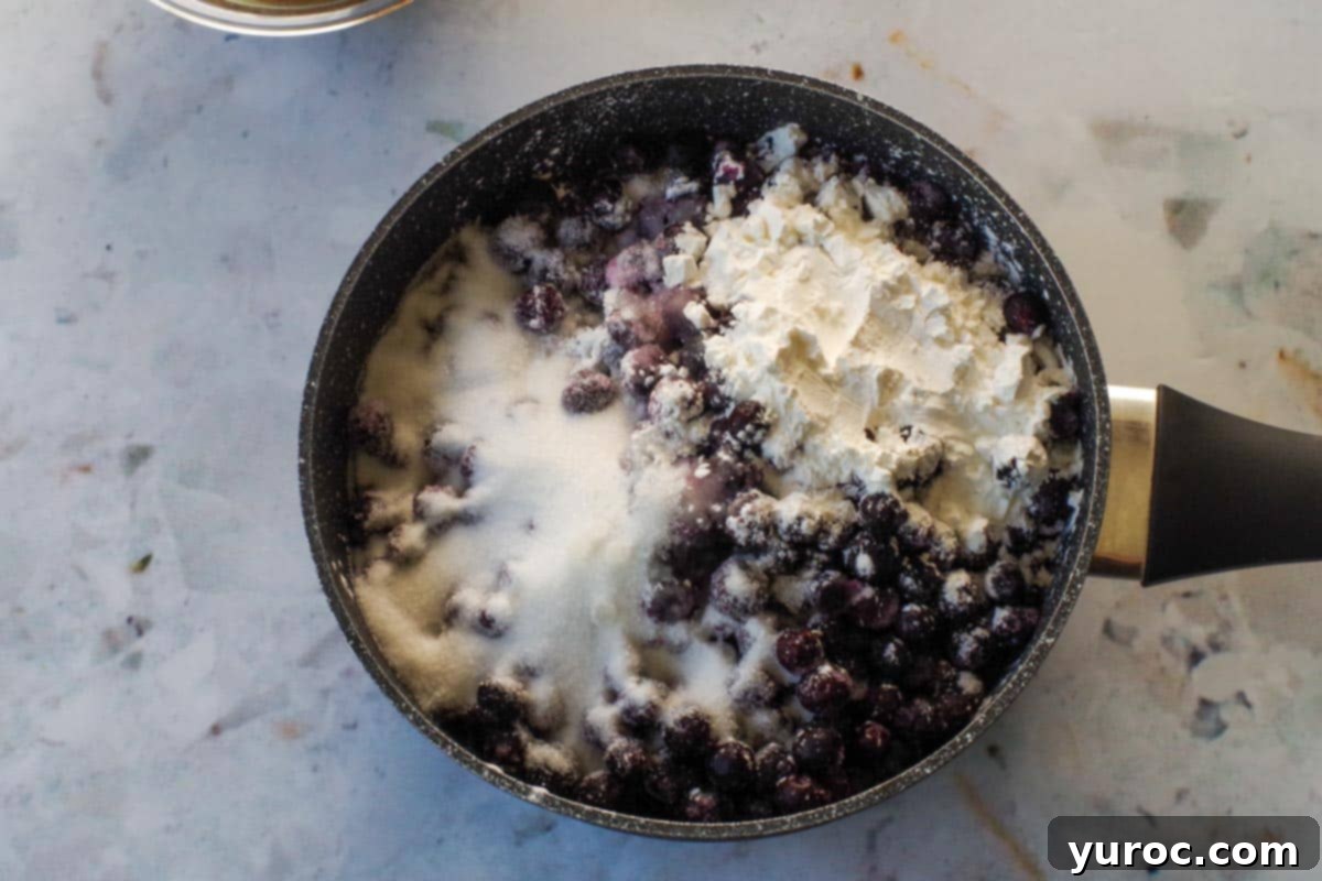 Saskatoon Berry Bliss Bars 4 cornstarch, water, sugar and lemon juice mixed with Saskatoon berries in saucepan.