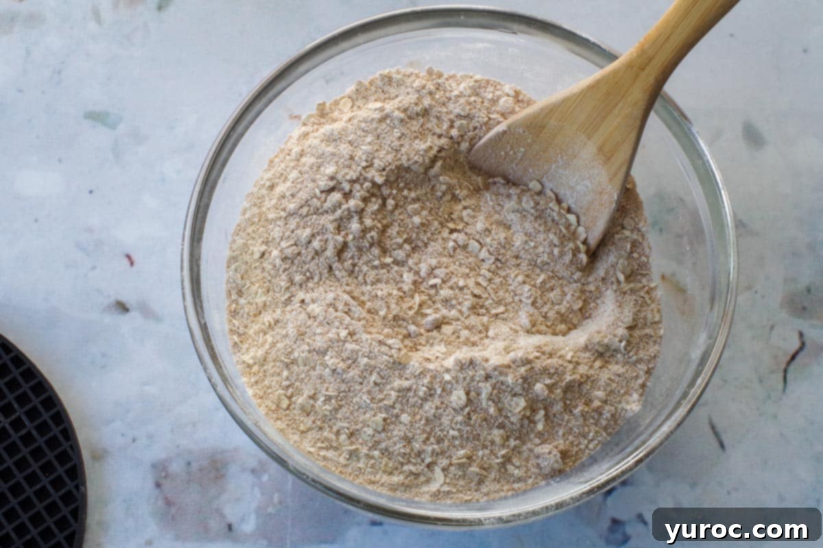 Saskatoon Berry Bliss Bars 8 brown sugar, baking soda, oats and flour in a glass bowl with a wooden spoon