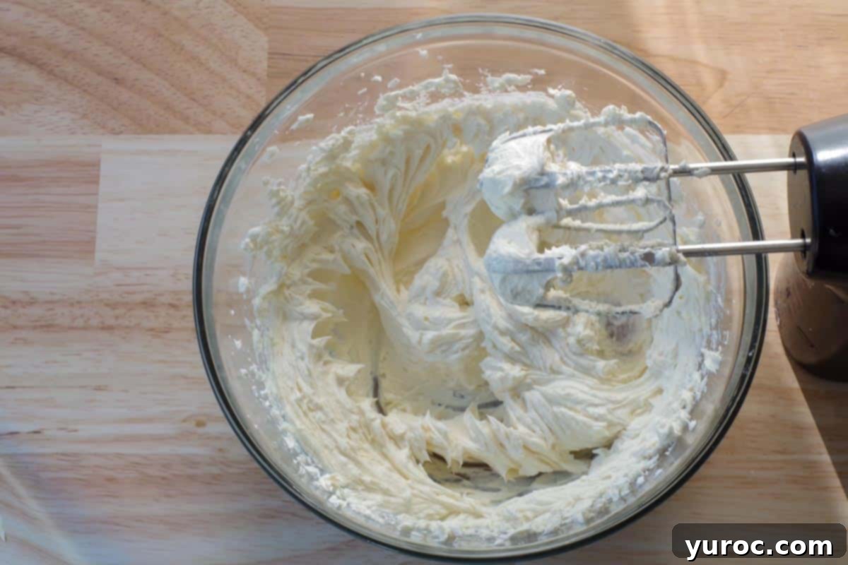Room temperature cream cheese and granulated sugar beaten together in a large glass bowl until light and fluffy.