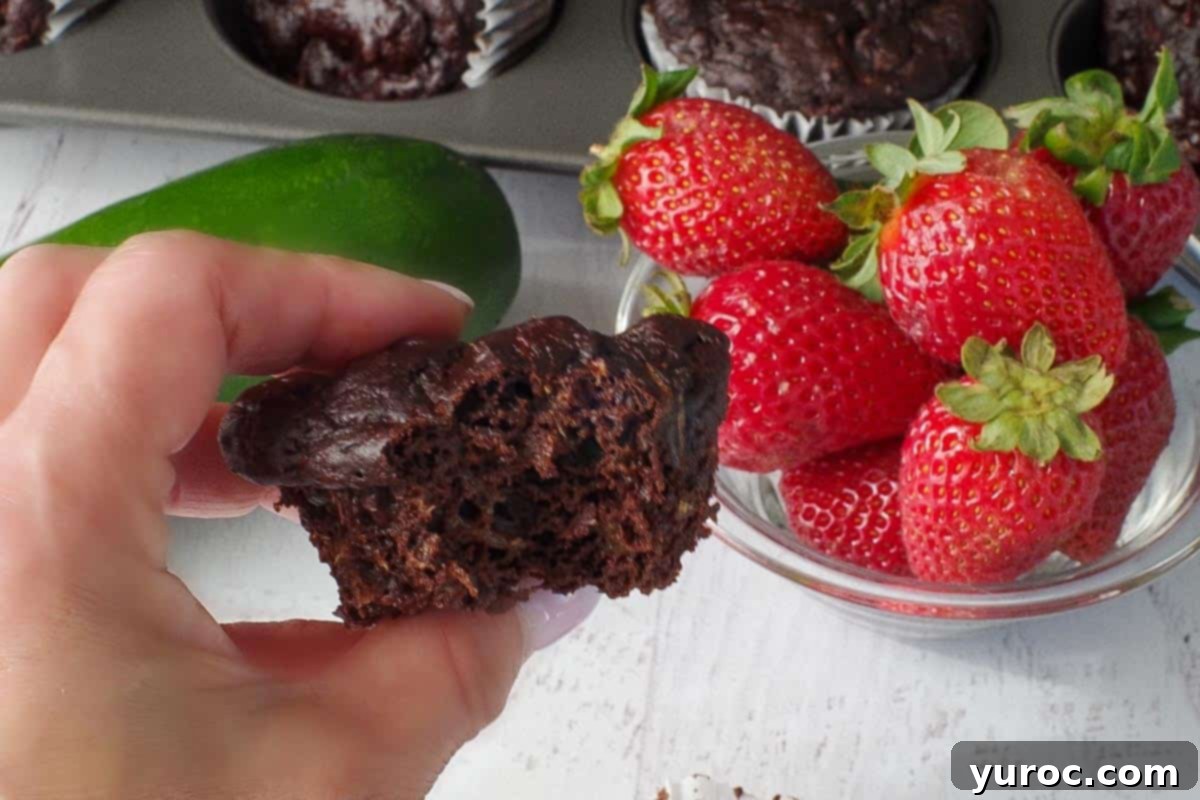 Weight Watchers chocolate zucchini muffin, with a bite taken out, being held by hand