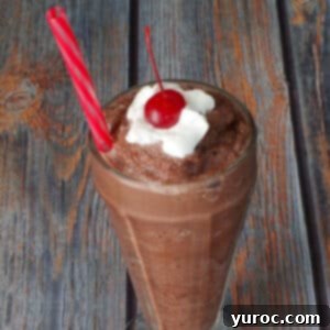 Skinny Chocolate Dream Frosty 7 Weight Watchers Chocolate Frosty in a tall soda glass, with a straw and a dollop of whipped cream and a cherry on top