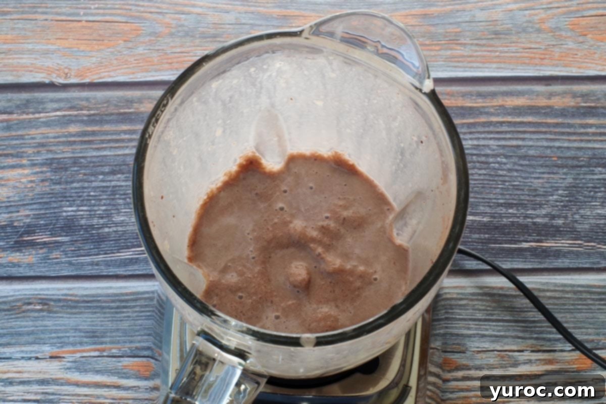 Skinny Chocolate Dream Frosty 5 The chocolate frosty ingredients are blended into a smooth, thick consistency within the blender, ready to be served.