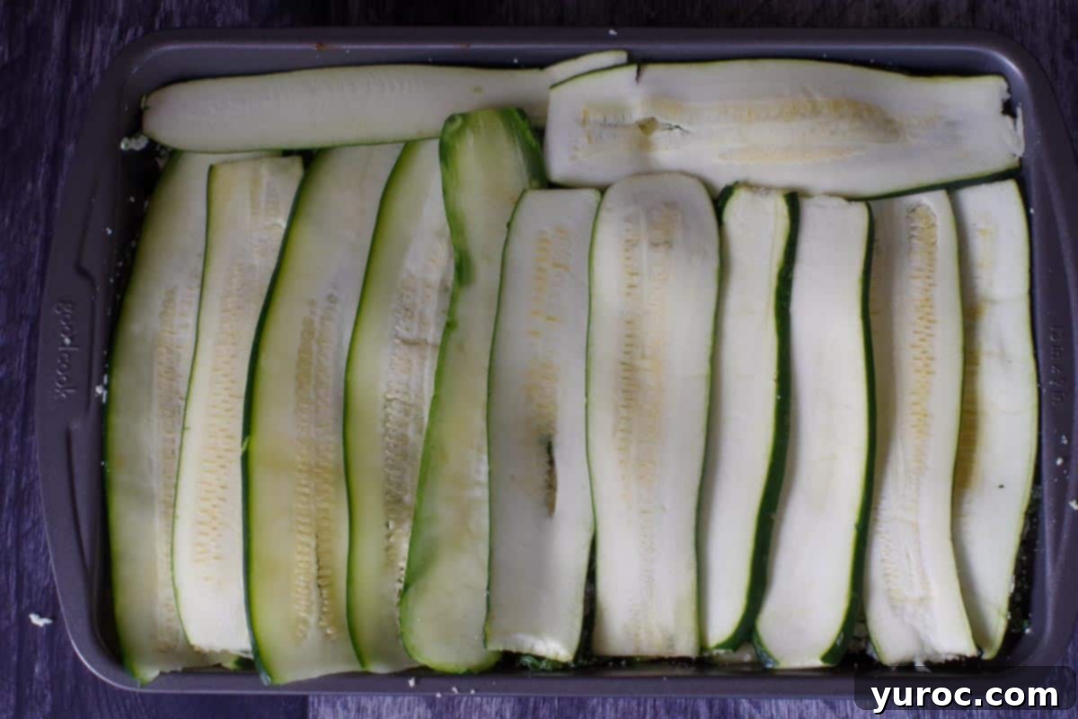 2nd layer of zucchini strips placed over the spinach cheese mixture in lasagna pan