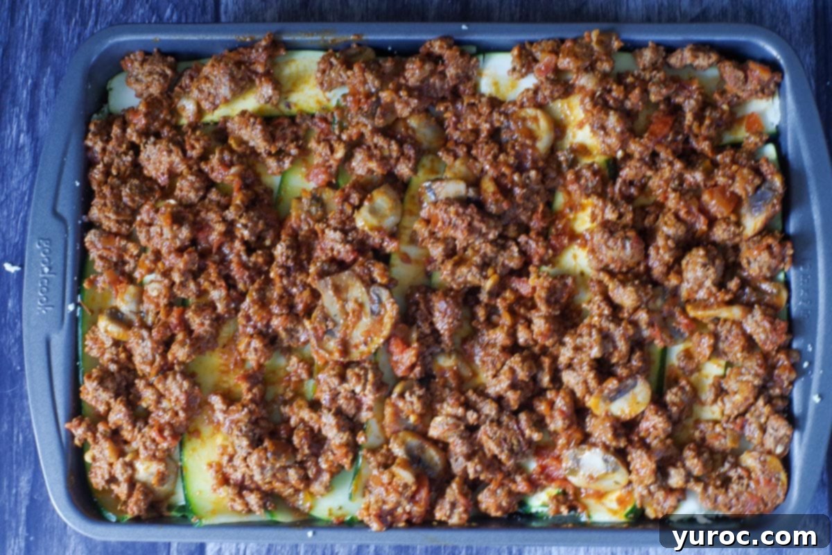 final layer of meat sauce spread over the zucchini is lasagna pan