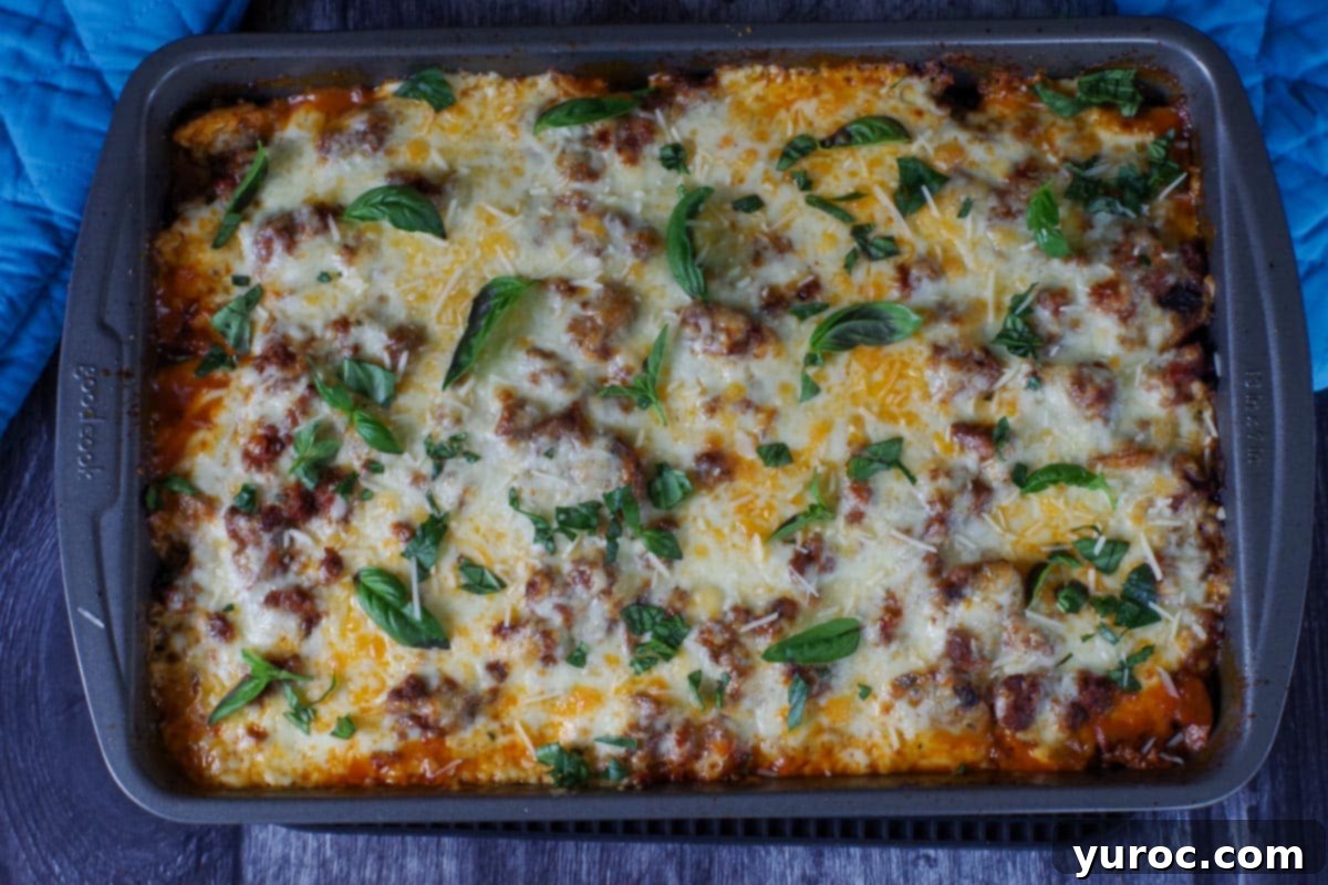 lasagna garnished with basil and parmesan cheese