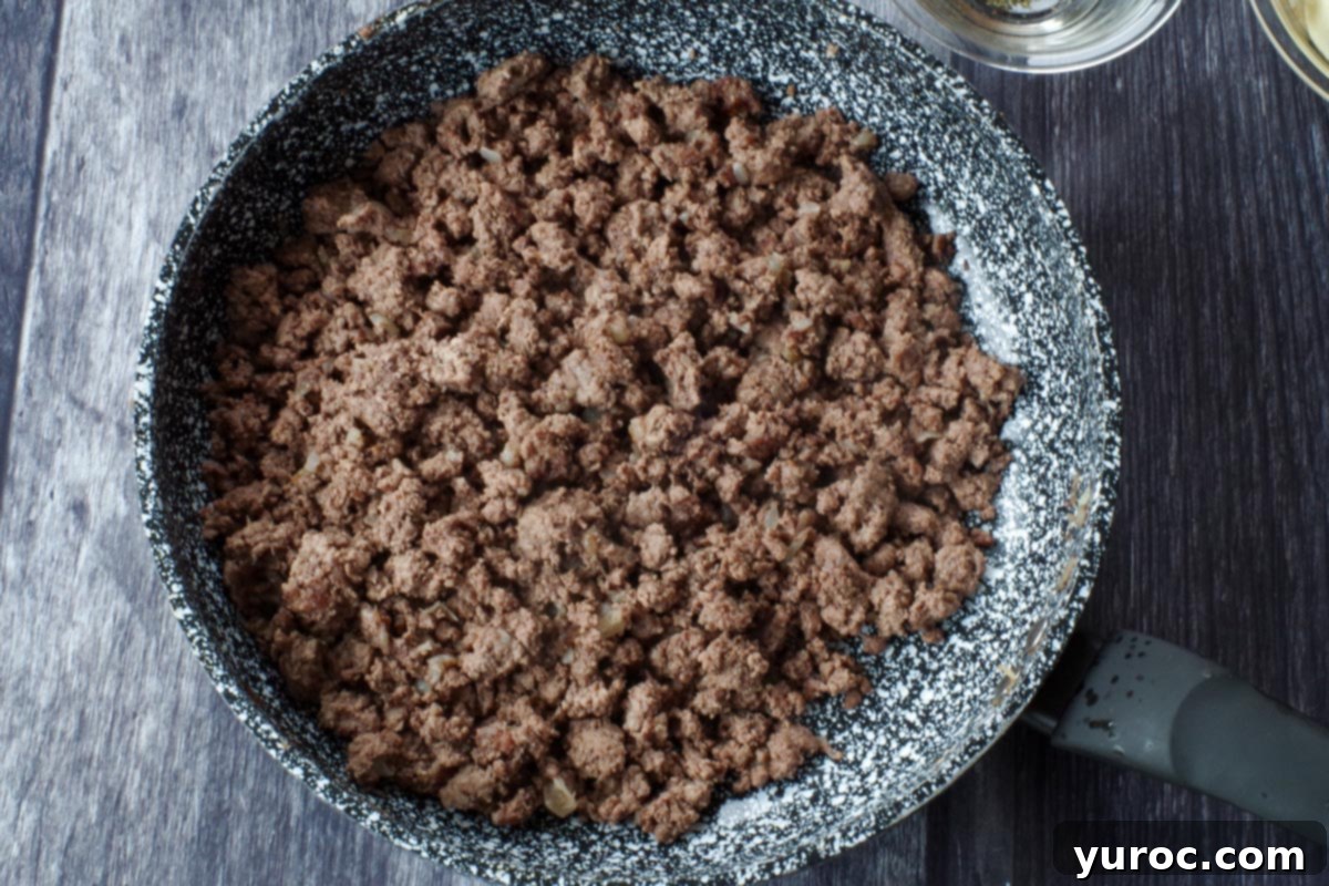 browned ground beef and onions in a skillet