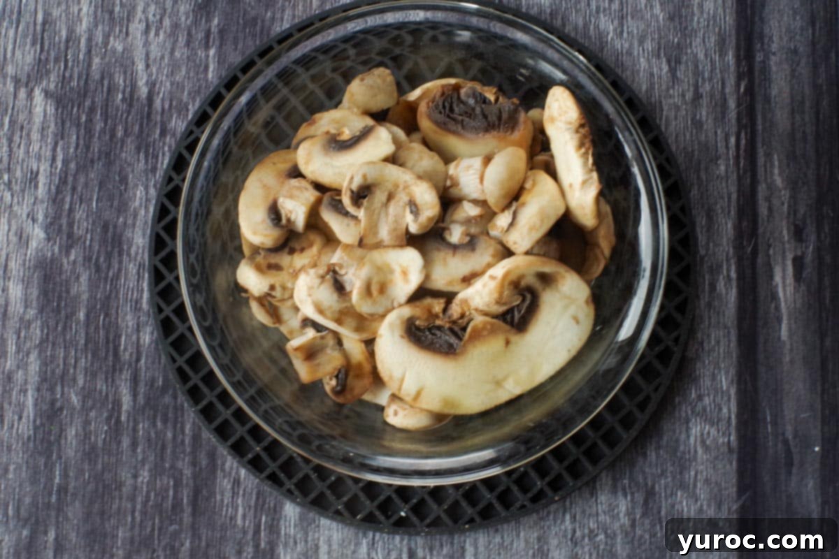 partially cooked mushrooms in a glass bowl