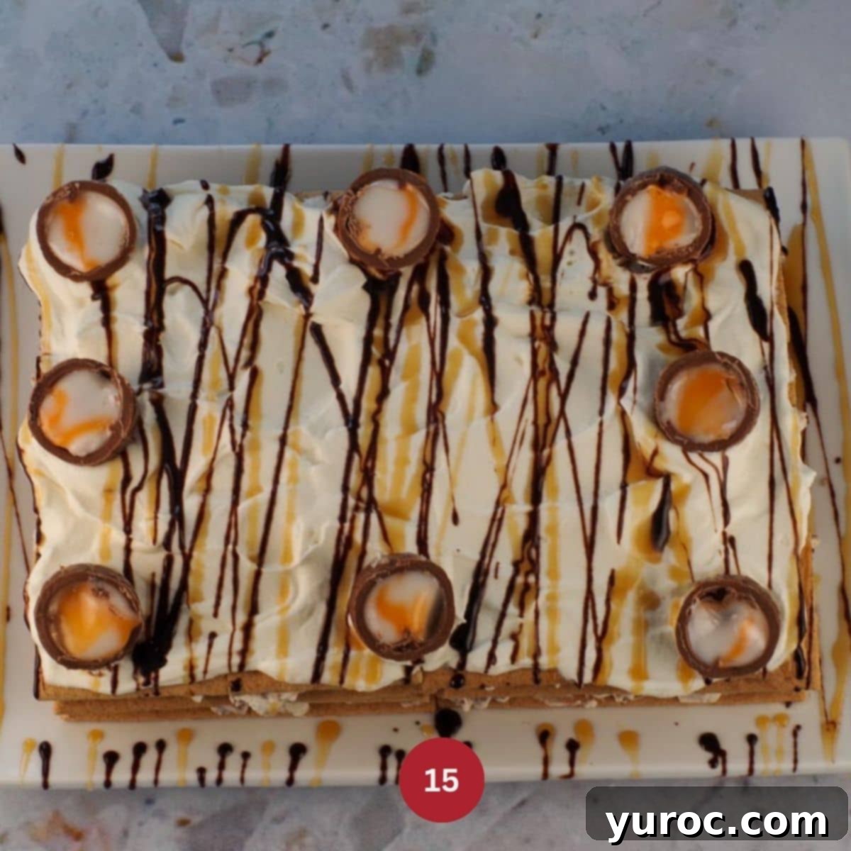 Easter Creme Egg Cake with garnish of 3-4 large Creme Eggs, cut in half, added to top of cake.