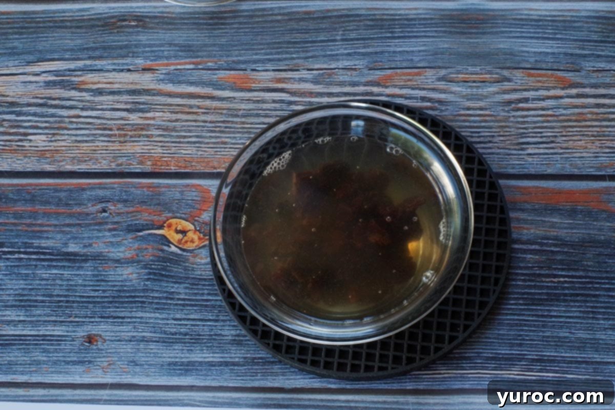 dried cherries in hot water in small glass bowl