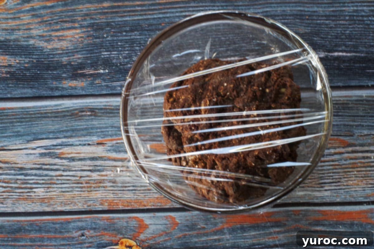 biscotti dough in a small glass bowl, covered with plastic wrap