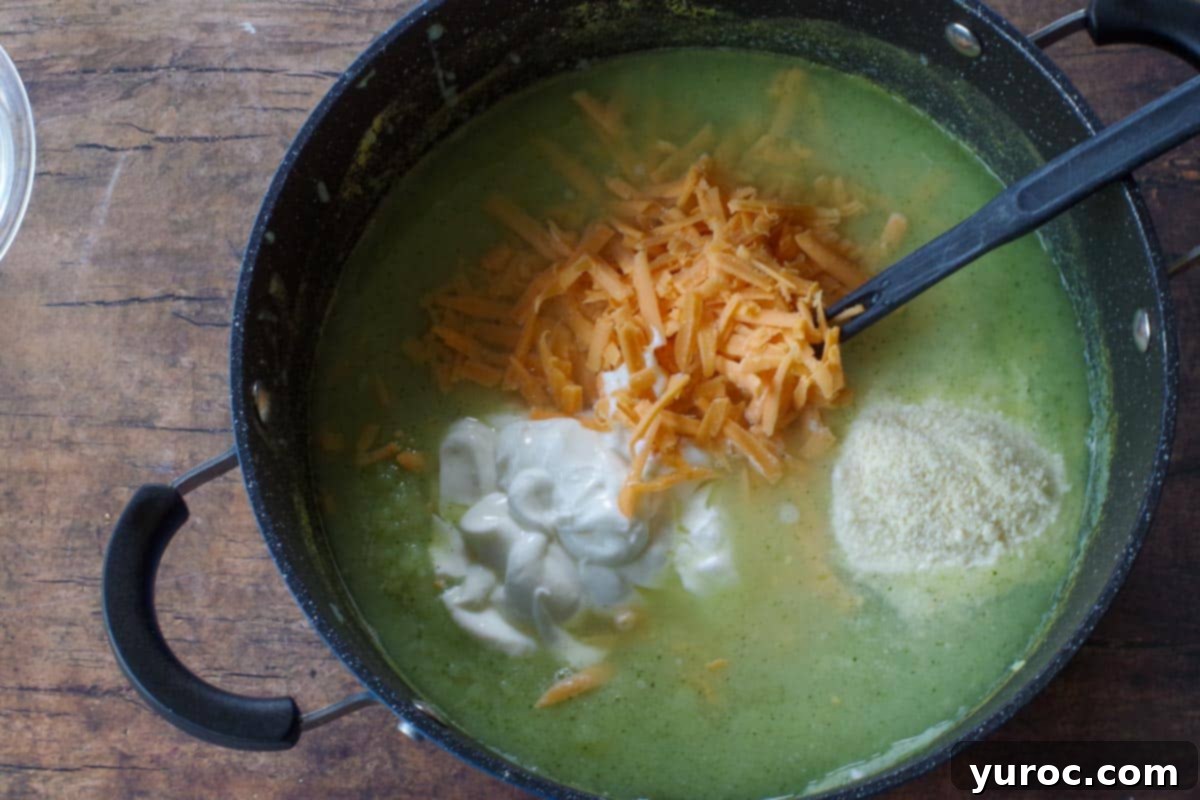 Wholesome Zucchini Potato Dill Soup 7 The pot containing the broth and pureed vegetables, with instant mashed potatoes, sour cream, Parmesan, cheddar cheese, and lime juice freshly added and being whisked into the creamy base.