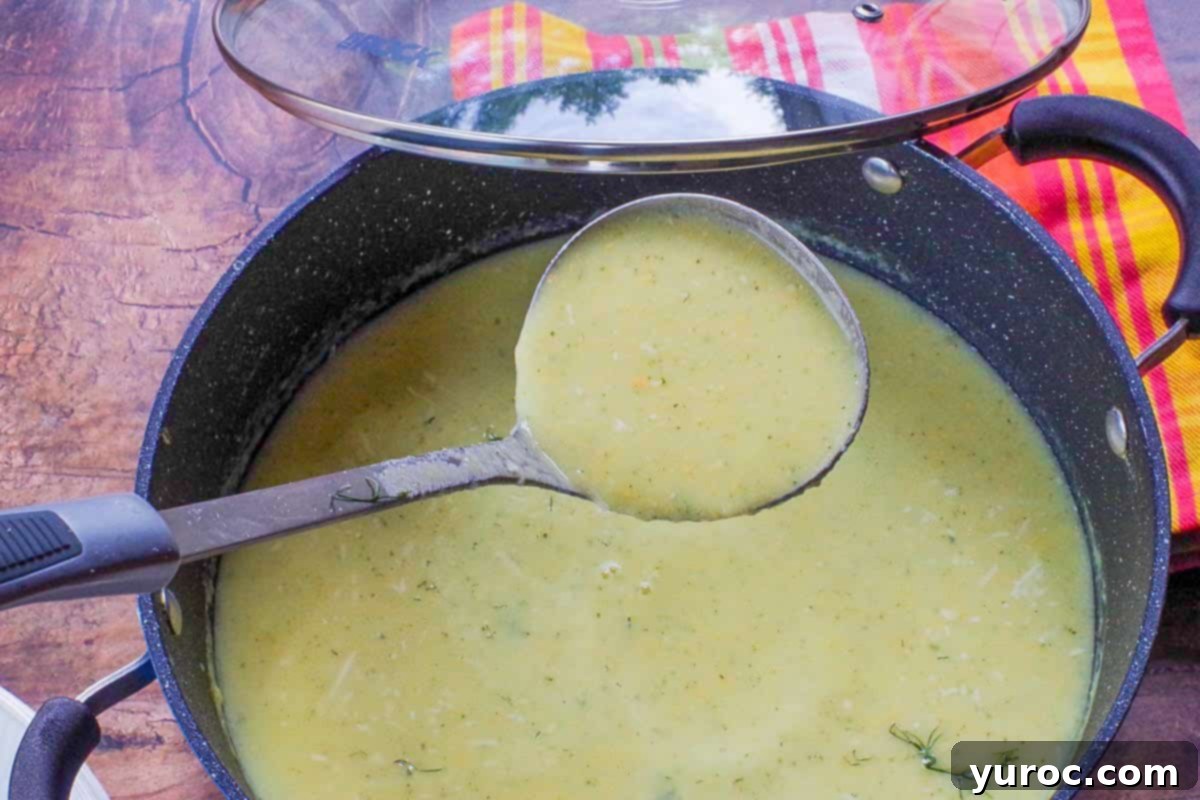 Wholesome Zucchini Potato Dill Soup 8 Rich, creamy Zucchini Potato Soup being ladled from a large pot into serving bowls.