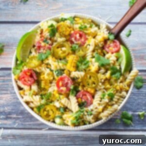Grilled Mexican Street Corn Pasta Salad in a white bowl from the top view