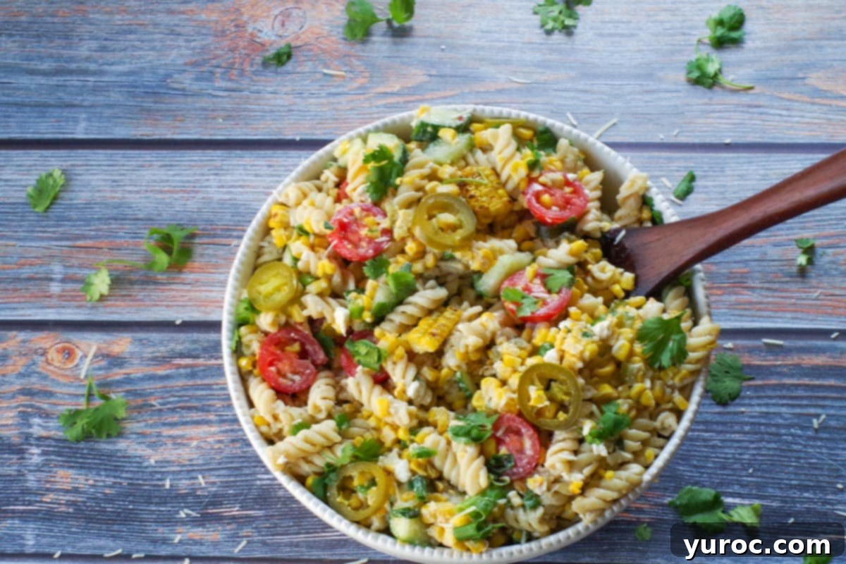 salad mixed together with a dark brown wooden spoon in bowl.