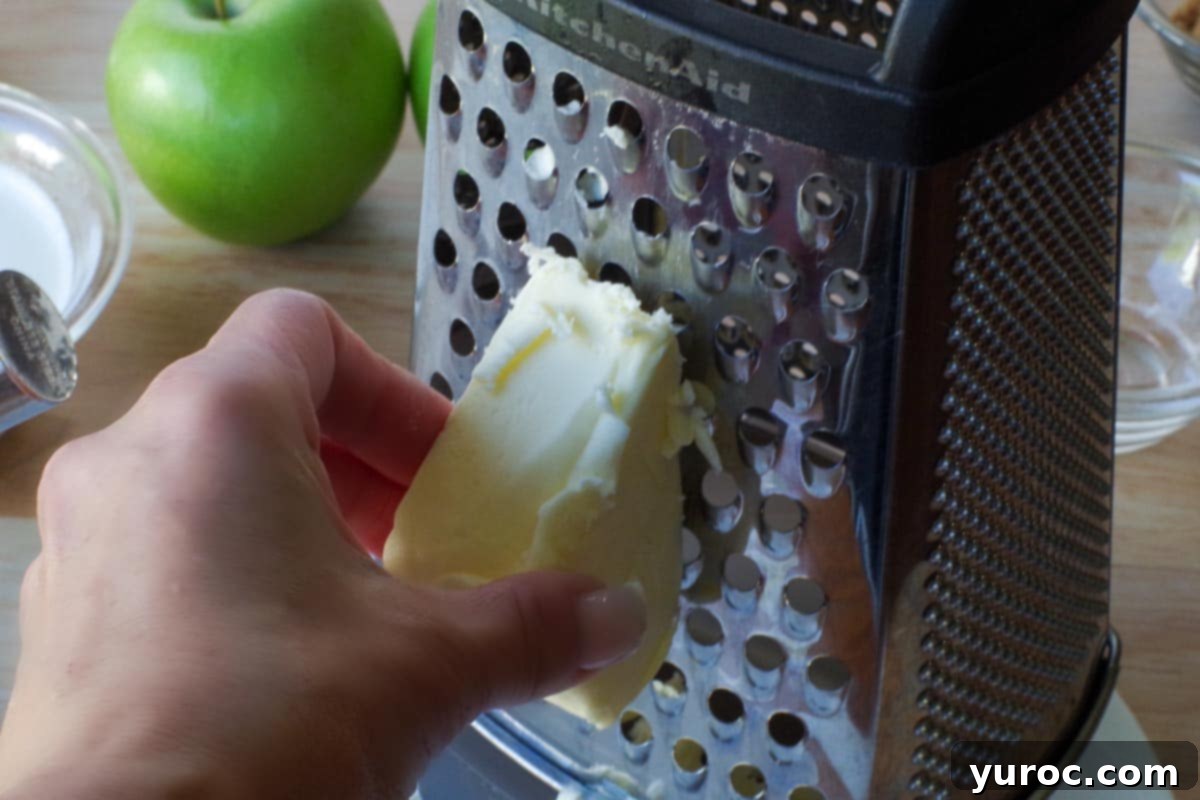 frozen butter being grated on a cheese grater
