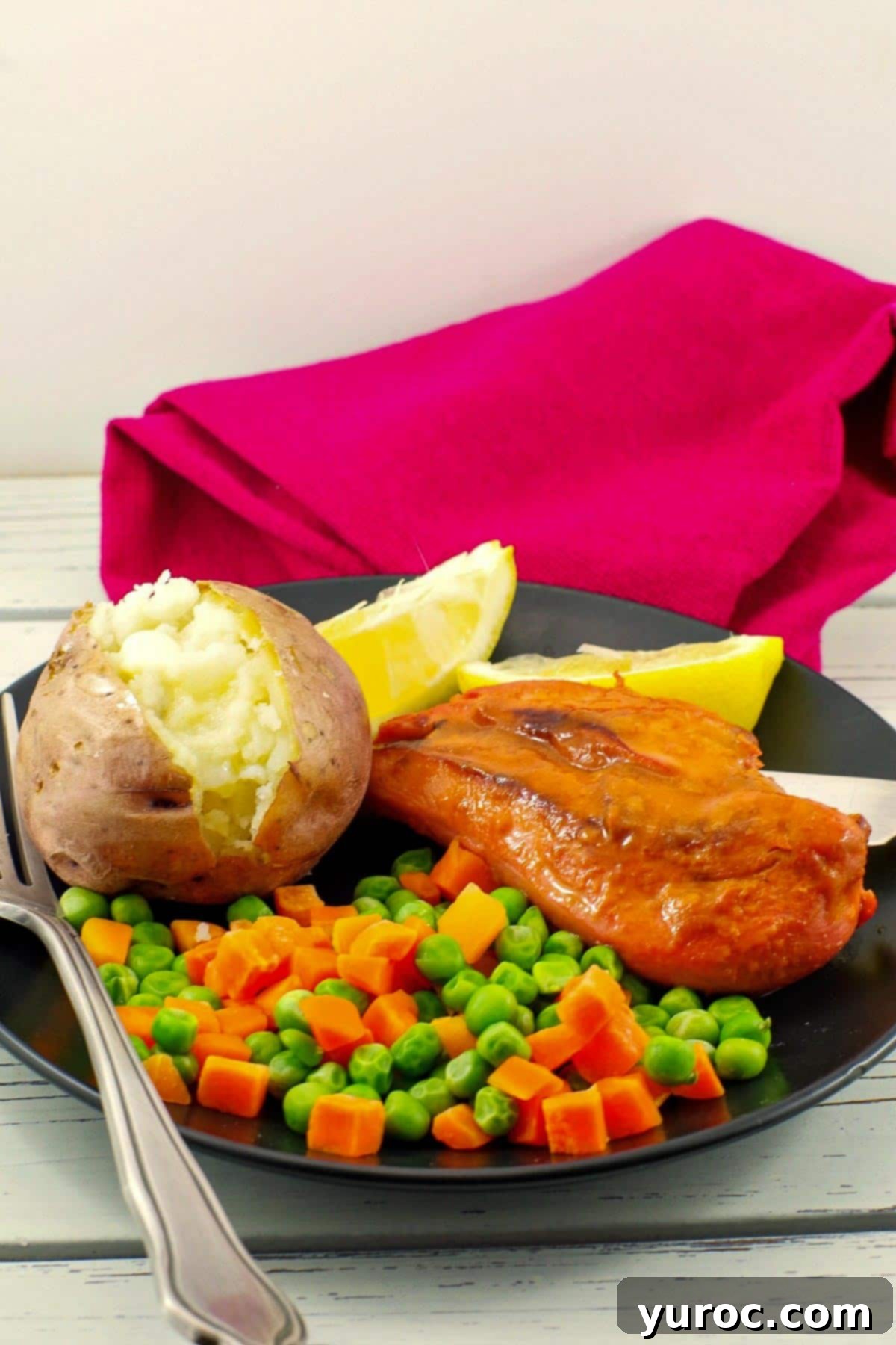 Bonanza Monterey chicken on plate with baked potato and mixed vegetables