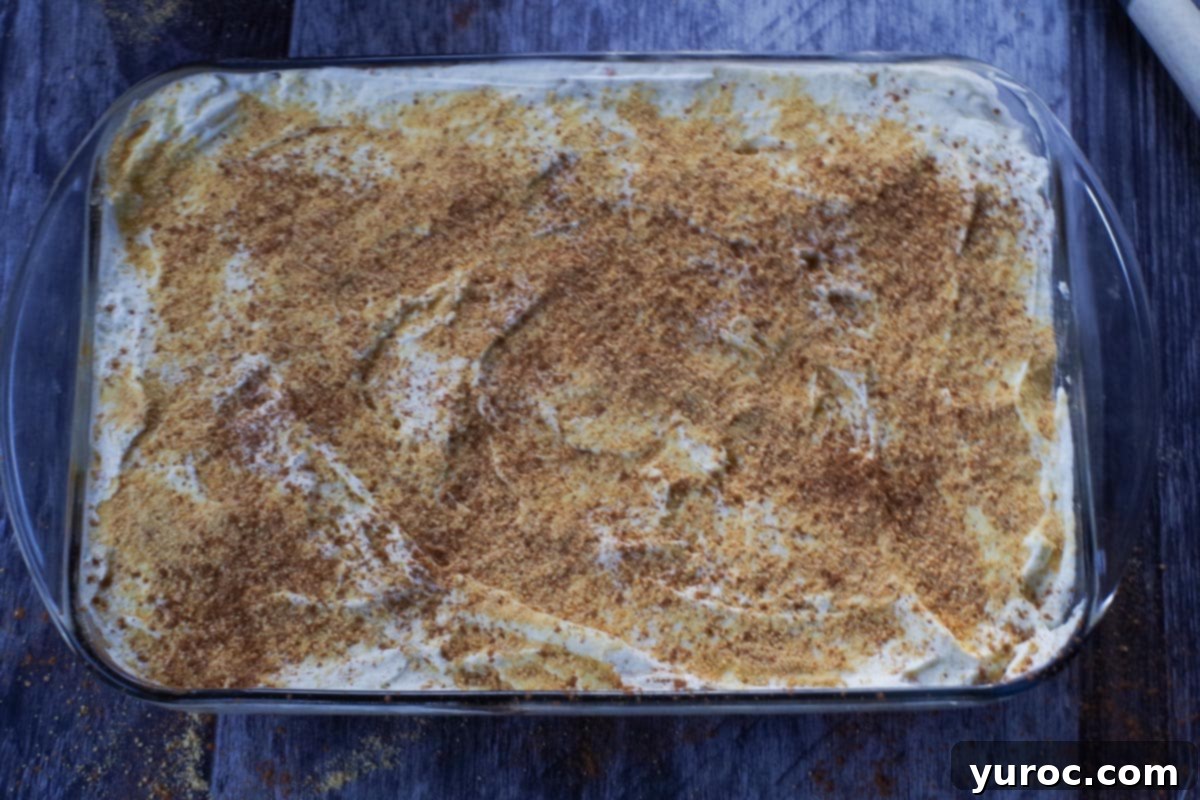 Effortless Pumpkin Perfection 13 The finished layered pumpkin dessert, with whipped cream spread over the pumpkin layer and sprinkled with graham crumbs and cinnamon.