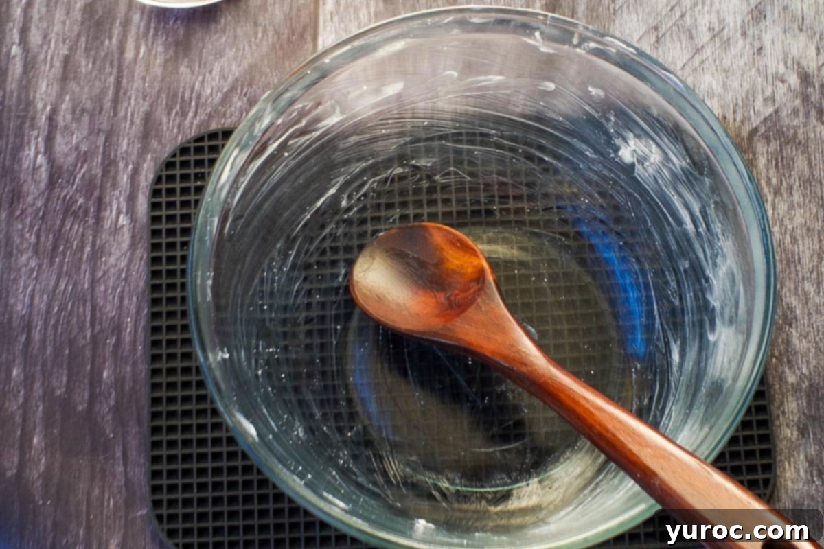 Effortless Pumpkin Perfection 15 A glass bowl and a wooden spoon, both lightly greased with shortening, demonstrating the top tip for marshmallow preparation.