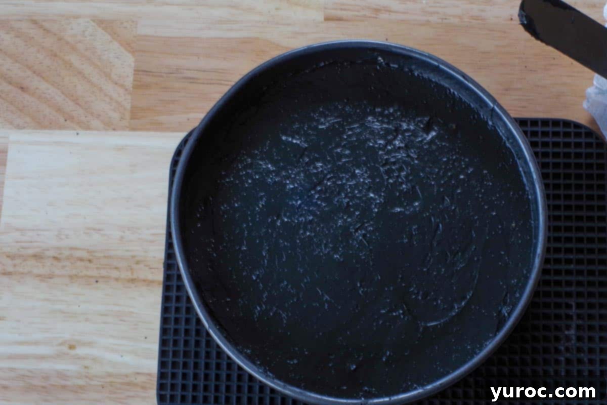Cheesecake in springform pan on a black trivet