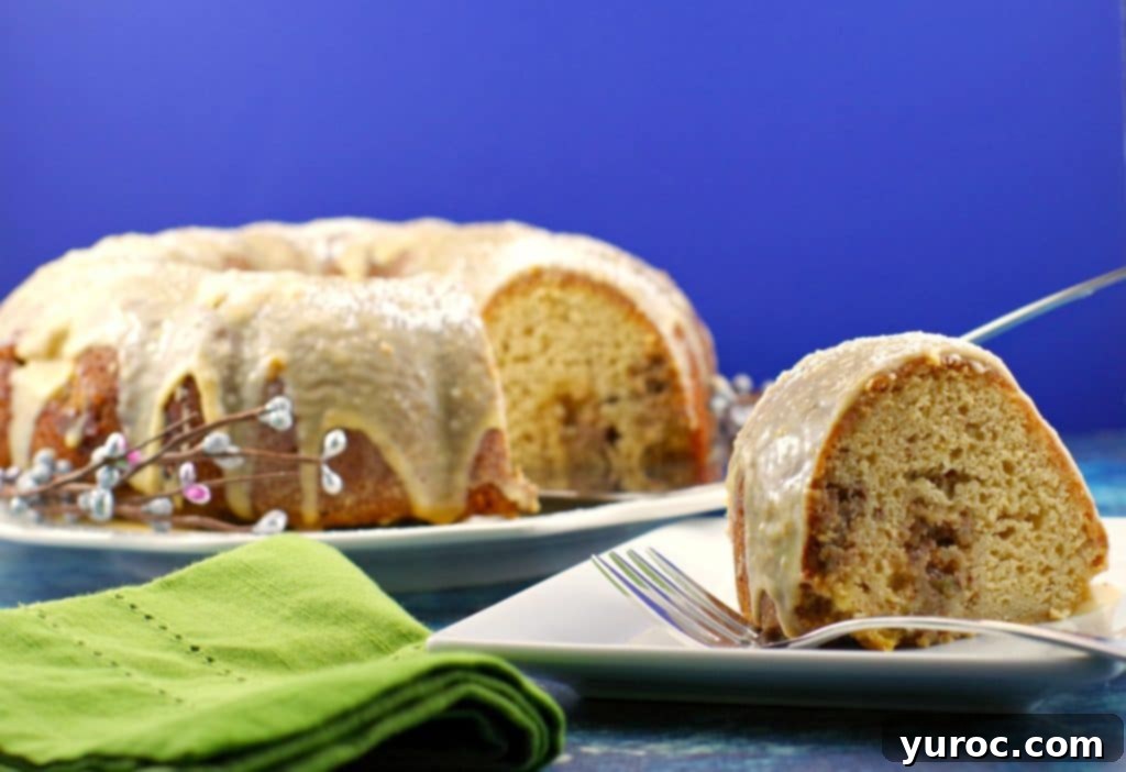 Close-up of a slice of Butter Tart Cake with the gooey filling swirl visible, served as a festive dessert.