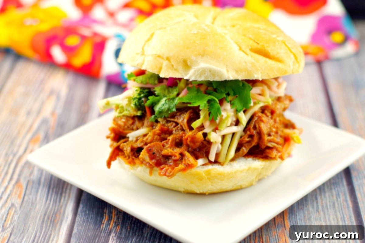 Slow Cooker Pulled Pork on a bun | #crockpotpulledpork- Foodmeanderings.com