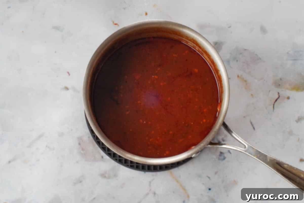 Sauce from slow cooker reduced by ⅓ in saucepan.