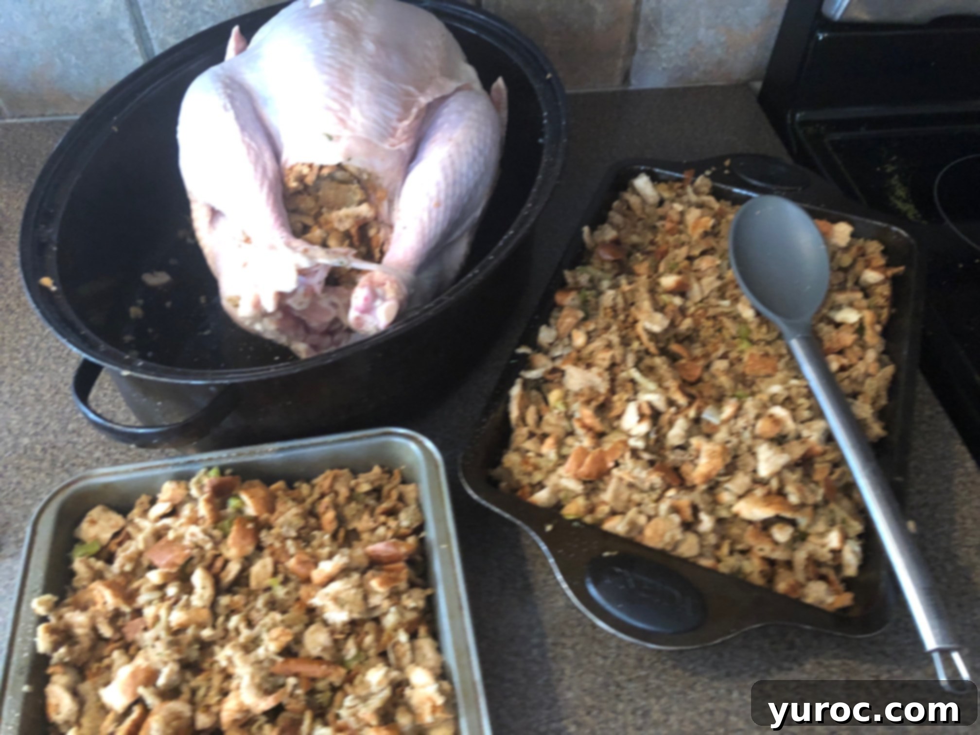 A large roasted turkey in a roasting pan, ready to be basted and served with stuffing.