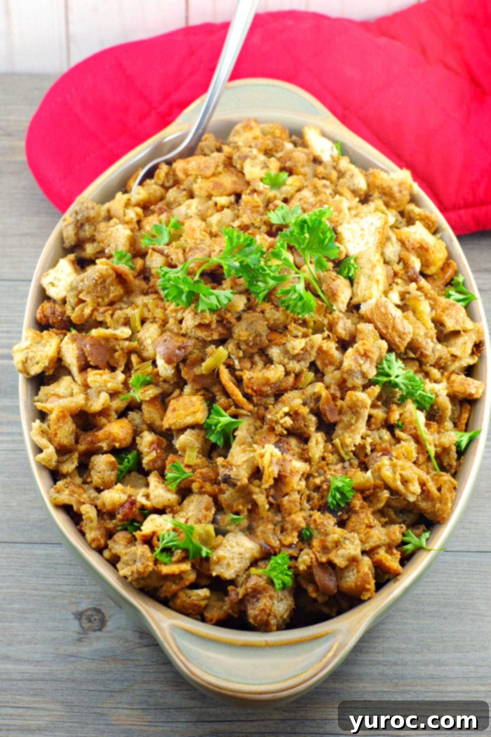 Old fashioned Savoury Bread Stuffing, presented beautifully in a green baking dish for a holiday meal.